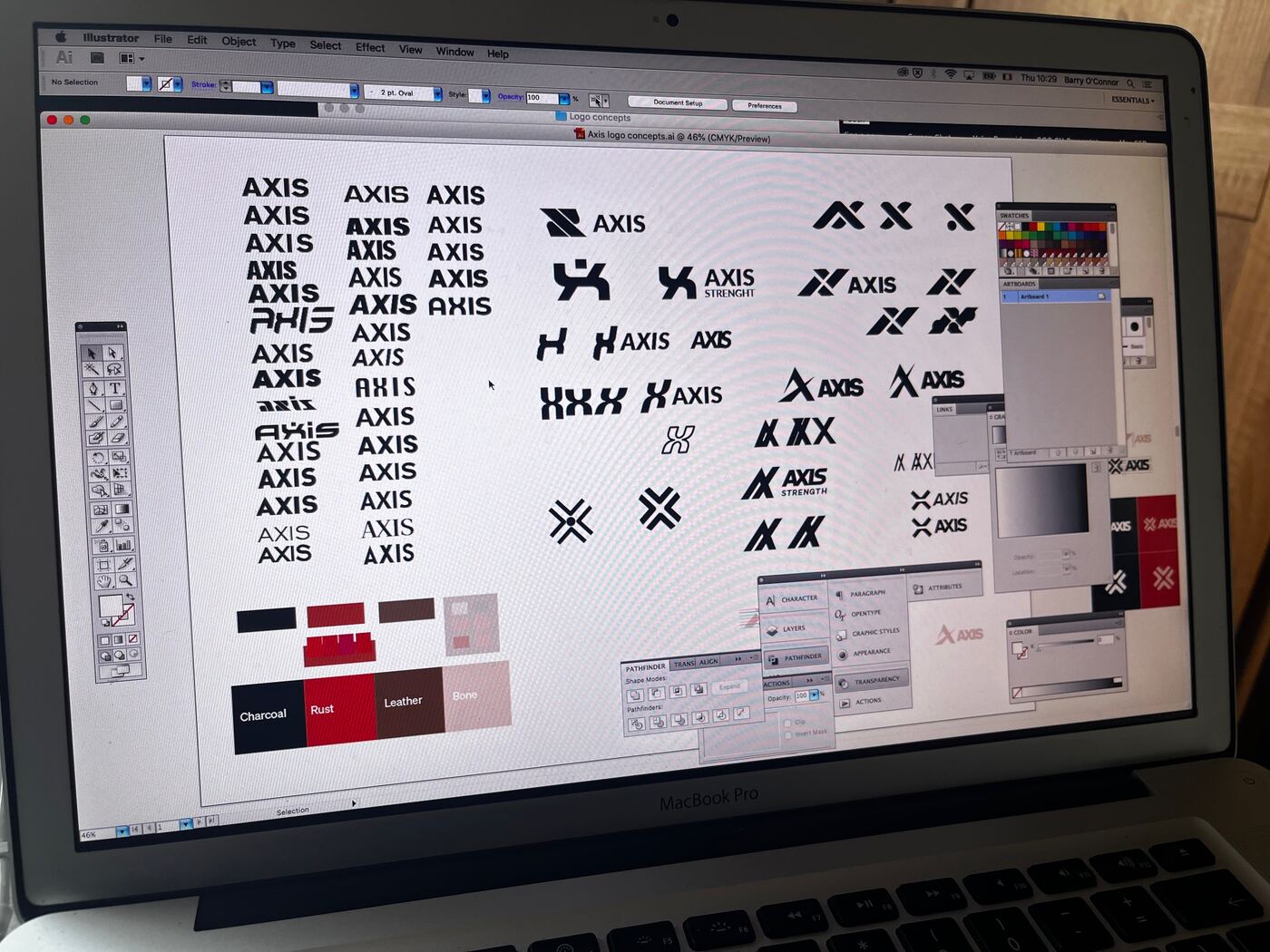 Dozens of A and X marks and AXIS wordmarks being worked up on screen in Illustrator