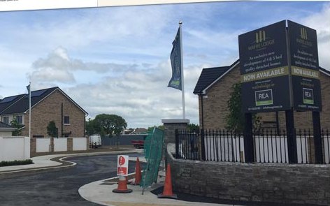 Wafre Lodge entrance signage and flag at the development in Ashbourne